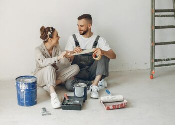 young cute couple repairs room after getting home repairs grants from government-concept